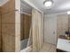 Well-lit bathroom featuring tiled shower with stylish curtain and modern fixtures at 1202 Coan Dr, Locust Grove, GA 30248