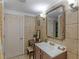 Well-maintained bathroom boasting tile accents, a vanity, and ample lighting at 1202 Coan Dr, Locust Grove, GA 30248