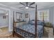 Comfortable bedroom featuring a poster bed, wooden furniture and an open door at 1202 Coan Dr, Locust Grove, GA 30248