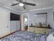 Cozy bedroom showcasing a wooden bedframe, ceiling fan and an open door at 1202 Coan Dr, Locust Grove, GA 30248