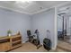 Bedroom area with view into another bedroom featuring a spin bike and suitcase at 1202 Coan Dr, Locust Grove, GA 30248