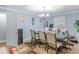 Traditional dining room with a large table, comfortable chairs, and a chandelier at 1202 Coan Dr, Locust Grove, GA 30248