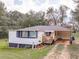 A charming one-story home with a cozy front porch and a carport area at 1202 Coan Dr, Locust Grove, GA 30248