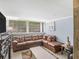 Cozy living room with a large sectional couch, decorative pillows, and a view of the outdoor landscape at 1202 Coan Dr, Locust Grove, GA 30248