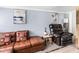 Living room featuring an elegant sofa, leather recliner, decorative pillows, and calming atmosphere at 1202 Coan Dr, Locust Grove, GA 30248