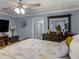 Comfortable main bedroom showcasing ceiling fan, wooden furniture and warm accents at 1202 Coan Dr, Locust Grove, GA 30248