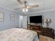 Inviting bedroom displaying a ceiling fan, TV, and wooden furniture at 1202 Coan Dr, Locust Grove, GA 30248