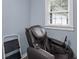 Relaxing room showcasing a modern massage chair with natural light streaming through the window at 1202 Coan Dr, Locust Grove, GA 30248