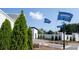 Entrance to the DR Horton community, featuring flags, trees, and white brick walls at 1826 Butterfly Way, Marietta, GA 30066
