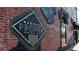 Exterior view of brick building featuring a decorative sign for Marietta Proper, a wine bar and cafe at 1826 Butterfly Way, Marietta, GA 30066
