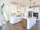Open concept kitchen with stainless steel appliances, quartz countertops, white cabinets and wood flooring at 1826 Butterfly Way, Marietta, GA 30066