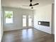 Modern living room featuring hardwood floors, fireplace, ceiling fan, and access to an outdoor patio at 1826 Butterfly Way, Marietta, GA 30066