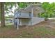 A charming home exterior features a covered porch and a painted brick foundation, nestled among mature trees at 2270 Cresta Dr, Decatur, GA 30032
