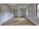 Open-concept living room with neutral walls, laminate flooring and a decorative support post at 2270 Cresta Dr, Decatur, GA 30032