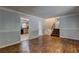 Living room featuring hardwood floors, staircase, and neutral paint, showing doorway into kitchen at 2270 Cresta Dr, Decatur, GA 30032