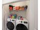 The laundry room features a front-load washer and dryer with shelving above at 3323 Owl Creek Pkwy, Acworth, GA 30102