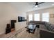 Modern living room featuring a comfortable sectional sofa, large TV, and stylish decor, perfect for relaxation and entertainment at 3323 Owl Creek Pkwy, Acworth, GA 30102