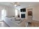 Bright living room with hardwood floors, fireplace, stylish furniture and decor, and a large window with natural light at 3323 Owl Creek Pkwy, Acworth, GA 30102