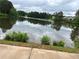 Relaxing view of the pond reflecting the sky, trees, and the building in the background at 3323 Owl Creek Pkwy, Acworth, GA 30102