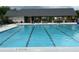 A clear view of the community swimming pool with lounge chairs, tables, and umbrellas for residents at 3323 Owl Creek Pkwy, Acworth, GA 30102
