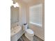Well-lit powder room featuring a pedestal sink, toilet, and window with blinds at 3323 Owl Creek Pkwy, Acworth, GA 30102