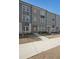 Stylish townhomes featuring neutral-colored brick and siding with well-maintained lawns and inviting front entrances at 3323 Owl Creek Pkwy, Acworth, GA 30102
