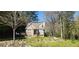Charming brick home with landscaped front yard and inviting entrance surrounded by a lush, natural setting at 120 Johnson Nw Rd, Atlanta, GA 30318