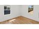 Bright bedroom with gleaming hardwood floors and natural light from two windows at 1385 Benteen Se Way, Atlanta, GA 30315