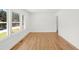 Bright and open bedroom featuring hardwood floors, fresh paint, and sunlit windows with neighborhood views at 1385 Benteen Se Way, Atlanta, GA 30315