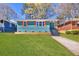 Charming blue home featuring orange shutters and a well-manicured front lawn, offering curb appeal at 1385 Benteen Se Way, Atlanta, GA 30315