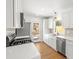 Modern kitchen with white cabinets, stainless steel appliances, quartz countertops, and backyard access at 1385 Benteen Se Way, Atlanta, GA 30315