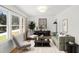 Cozy living room featuring modern decor, hardwood floors, and large windows for ample natural light at 1385 Benteen Se Way, Atlanta, GA 30315