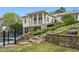 Landscaped backyard featuring a swimming pool and stone retaining wall with steps at 1724 Ridge Valley Nw Ct, Atlanta, GA 30327