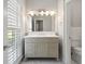 Bathroom featuring a vanity with cabinets, window, and tile flooring at 1724 Ridge Valley Nw Ct, Atlanta, GA 30327