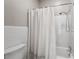 Bathroom featuring a shower and tub with white tile walls and a decorative shower curtain at 1724 Ridge Valley Nw Ct, Atlanta, GA 30327