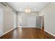 Well-lit bedroom with dark wood floors, closet, and multiple doors with bright trim at 1724 Ridge Valley Nw Ct, Atlanta, GA 30327