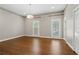 Large room featuring hardwood floors, bright trim, modern lighting, and windows for natural light at 1724 Ridge Valley Nw Ct, Atlanta, GA 30327
