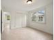 Bright bedroom features tile floor, large window, and closet with double doors at 1724 Ridge Valley Nw Ct, Atlanta, GA 30327