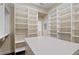 Custom walk-in closet featuring shelving, drawers, and an island for organization and storage at 1724 Ridge Valley Nw Ct, Atlanta, GA 30327