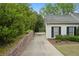 Long driveway leading to a white house surrounded by green landscaping at 1724 Ridge Valley Nw Ct, Atlanta, GA 30327