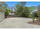 A long driveway with concrete paving, landscaping and a glimpse of the home's garage at 1724 Ridge Valley Nw Ct, Atlanta, GA 30327