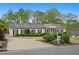 Charming one-story home features a landscaped front yard, covered porch, and driveway with mature trees at 1724 Ridge Valley Nw Ct, Atlanta, GA 30327