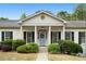 Inviting front entrance with classic columns, a blue door, and professionally landscaped bushes at 1724 Ridge Valley Nw Ct, Atlanta, GA 30327