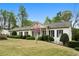 Beautifully landscaped front yard with a charming single-story home at 1724 Ridge Valley Nw Ct, Atlanta, GA 30327