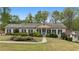 Charming single-story home with manicured lawn, mature trees, and a welcoming front porch at 1724 Ridge Valley Nw Ct, Atlanta, GA 30327