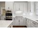 Kitchen showcasing custom white cabinets, stainless steel appliances, and white subway tile backsplash at 1724 Ridge Valley Nw Ct, Atlanta, GA 30327