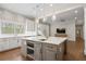 Open kitchen layout with a large gray island, marble countertops, and stainless steel appliances at 1724 Ridge Valley Nw Ct, Atlanta, GA 30327