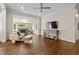 Bright living room featuring hardwood floors, a stone fireplace, and a flat screen TV at 1724 Ridge Valley Nw Ct, Atlanta, GA 30327