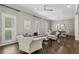 Comfortable living room featuring hardwood floors, stylish seating, and a view into the dining area at 1724 Ridge Valley Nw Ct, Atlanta, GA 30327