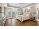 Inviting main bedroom features hardwood floors, tray ceiling, and access to a balcony at 1724 Ridge Valley Nw Ct, Atlanta, GA 30327